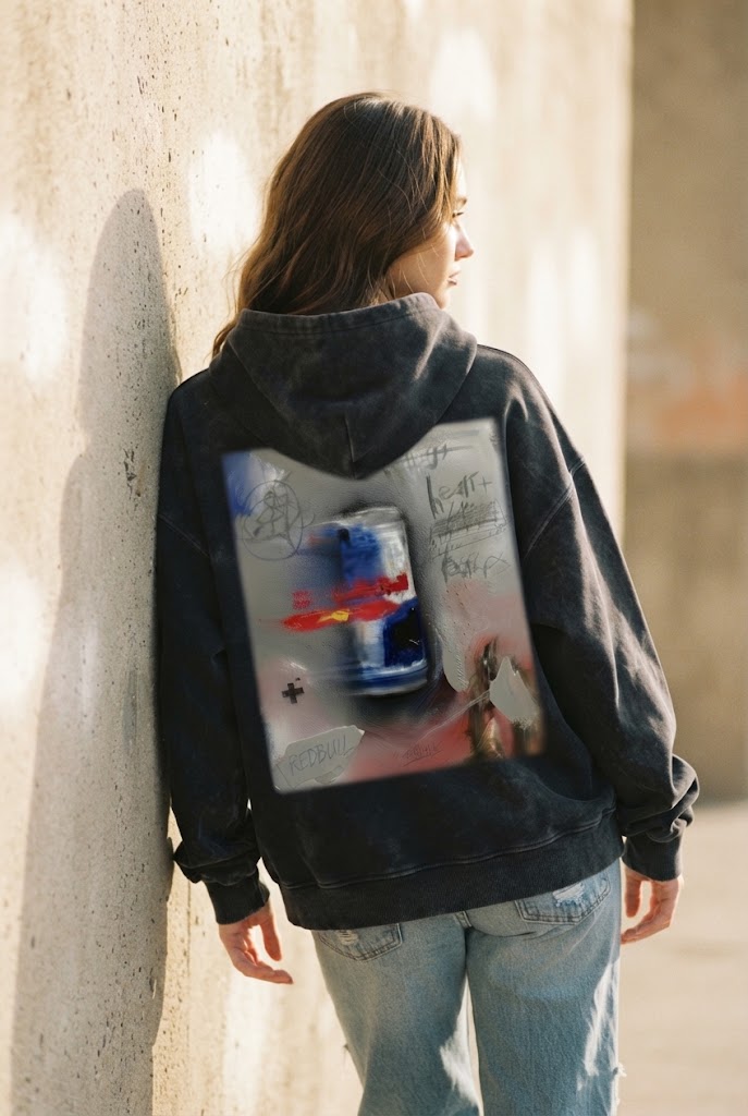 Model in the Curvite RB abstract graphic hoodie against a sunlit wall